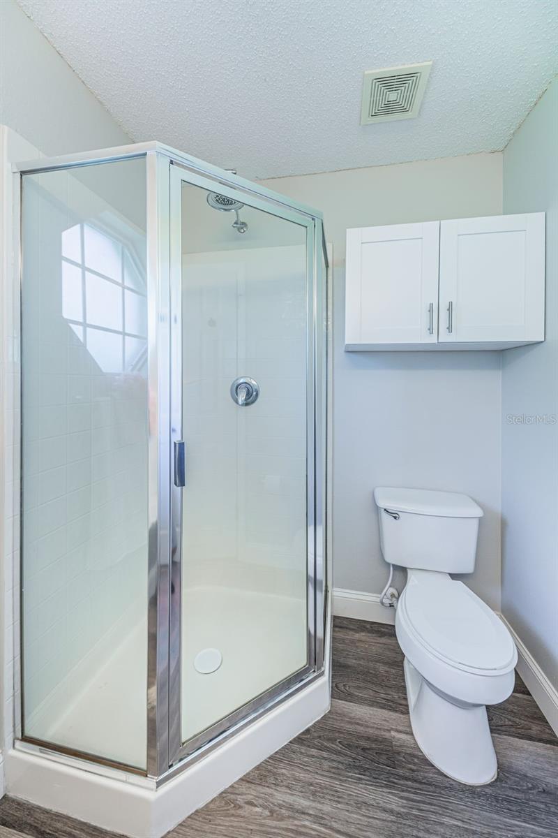 Bath with walk-in shower.