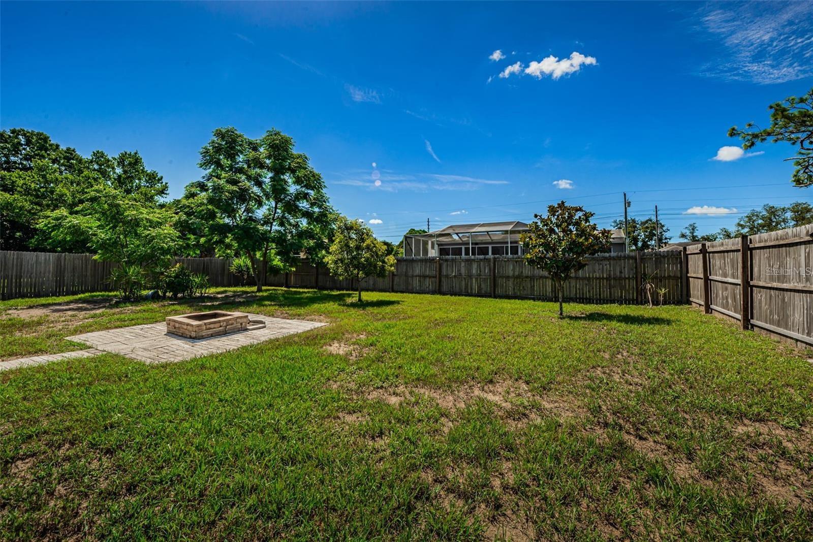 Private Hugh fenced yard and fire pit.