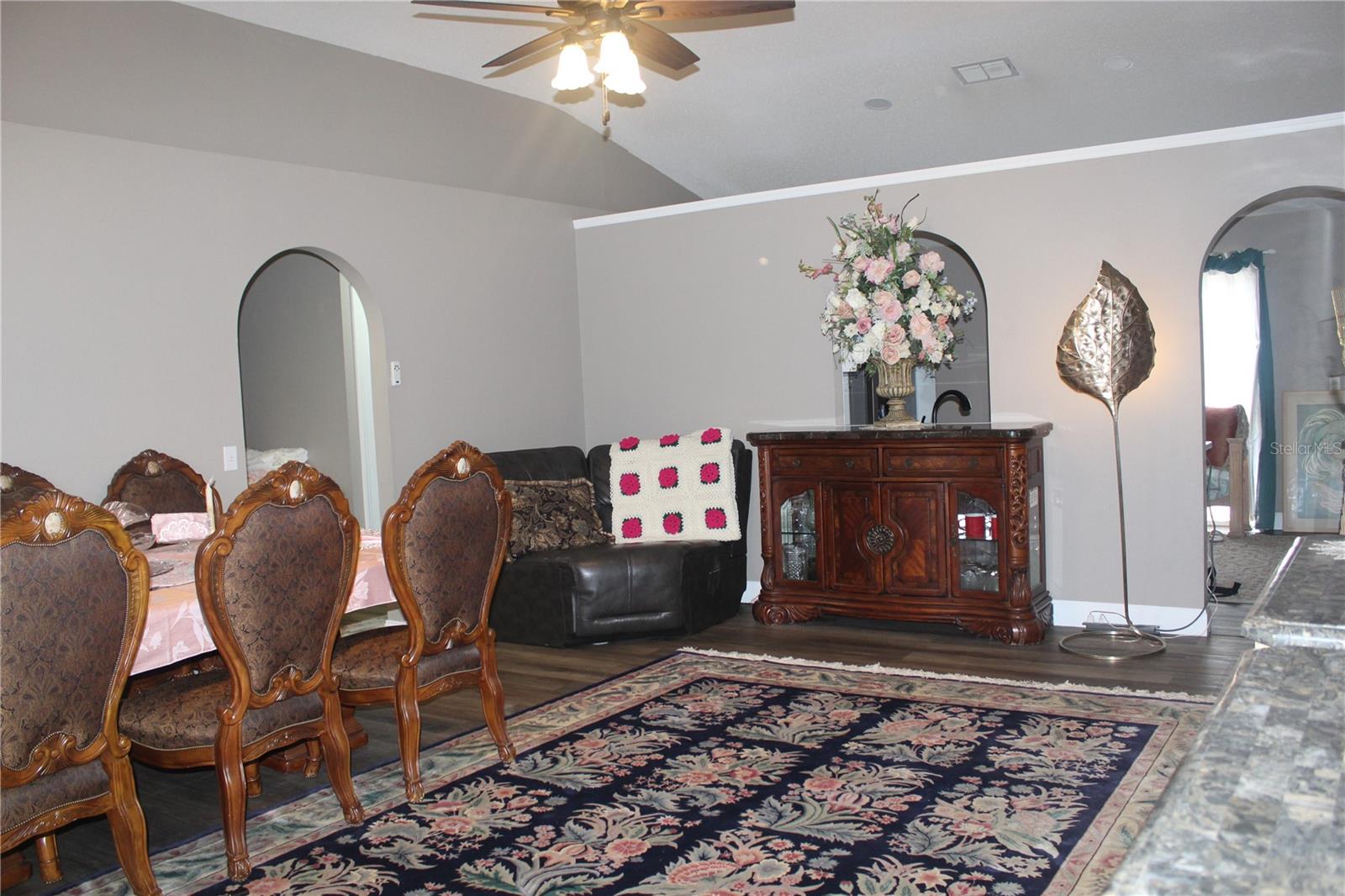 Living Room/Dining Room. Newer Vinyl Wood Flooring throughout with crown molding