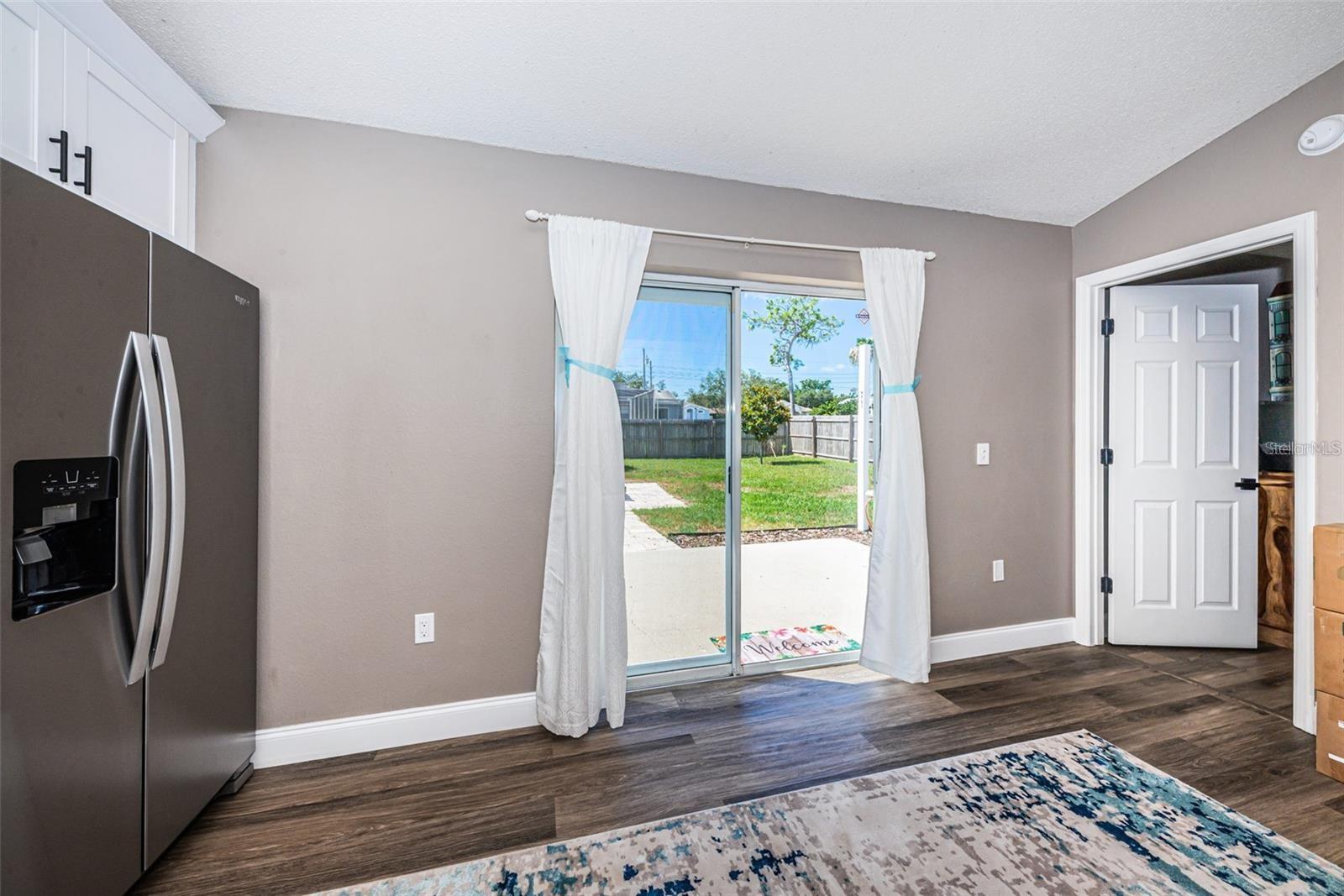 Sliding doors to private large fenced yard, patio and shed.