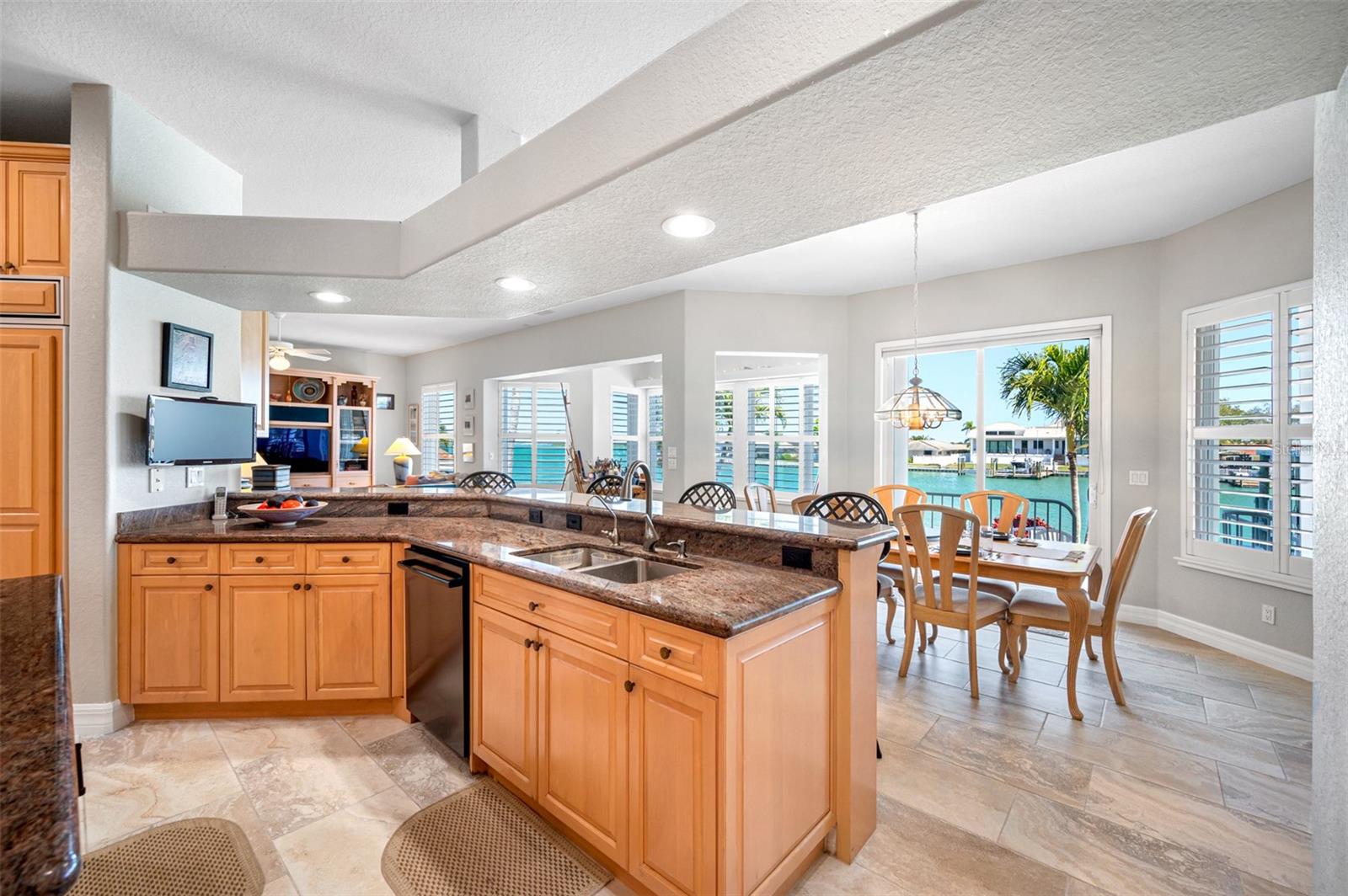 Kitchen is open to the large breakfast room and family room, all of which have water views.