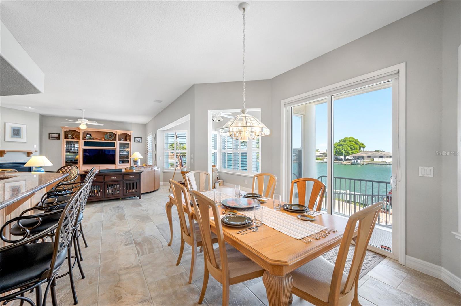 Large breakfast/dining area overlooking the water and adjacent to the kitchen and family room