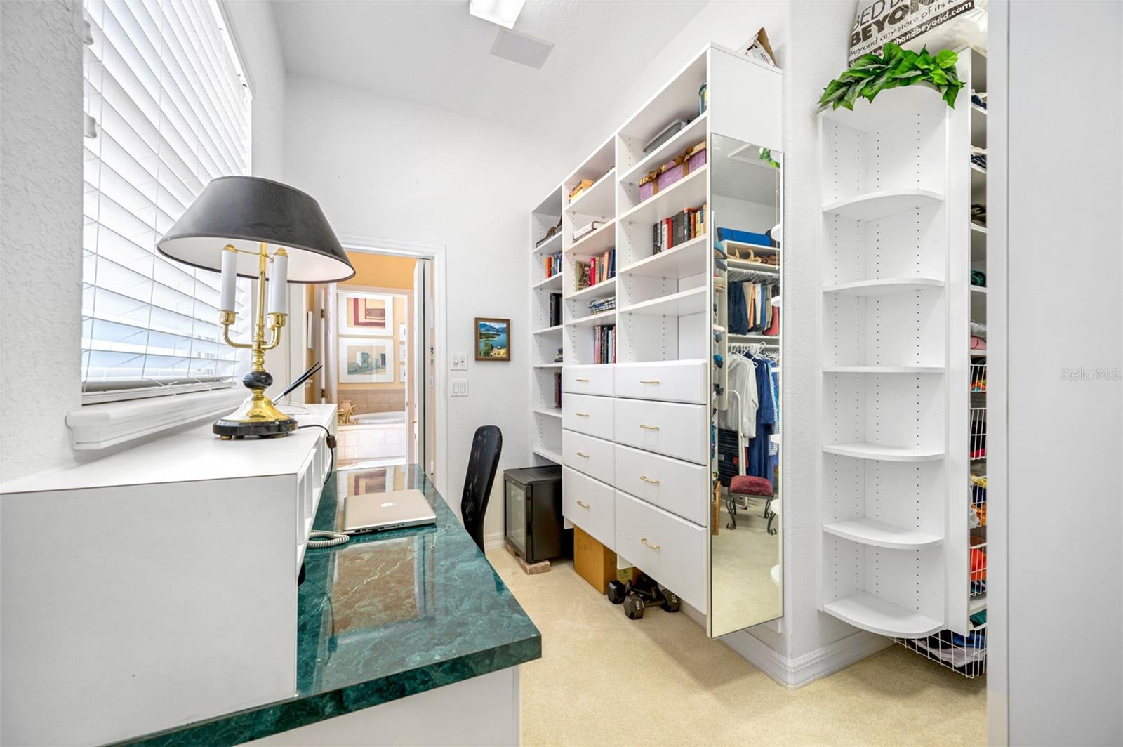 Private desk and storage area located within the his-and-hers walk-in closet