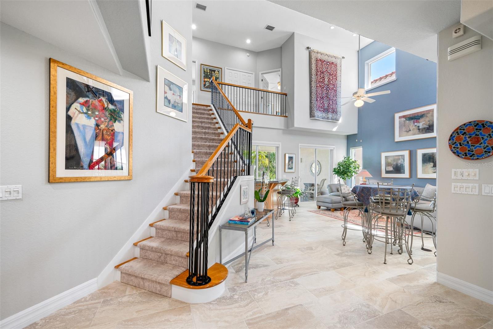 Entry foyer leads into living room with its soaring 21-ft high ceilings