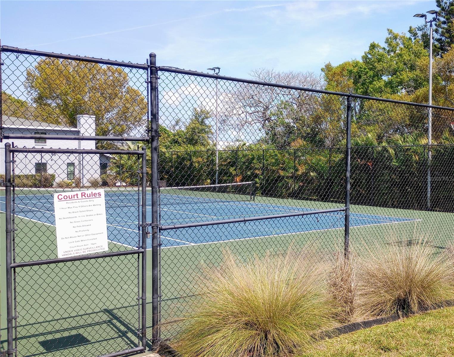 fenced tennis court