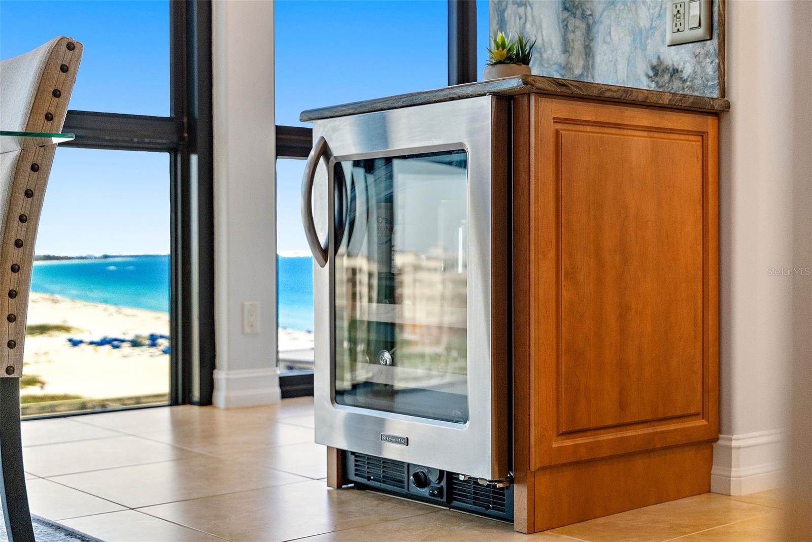 You can catch a glimpse of the beverage fridge here to the near-left corner. The wine fridge and dry bar is a nice feature, both practical and stylish!