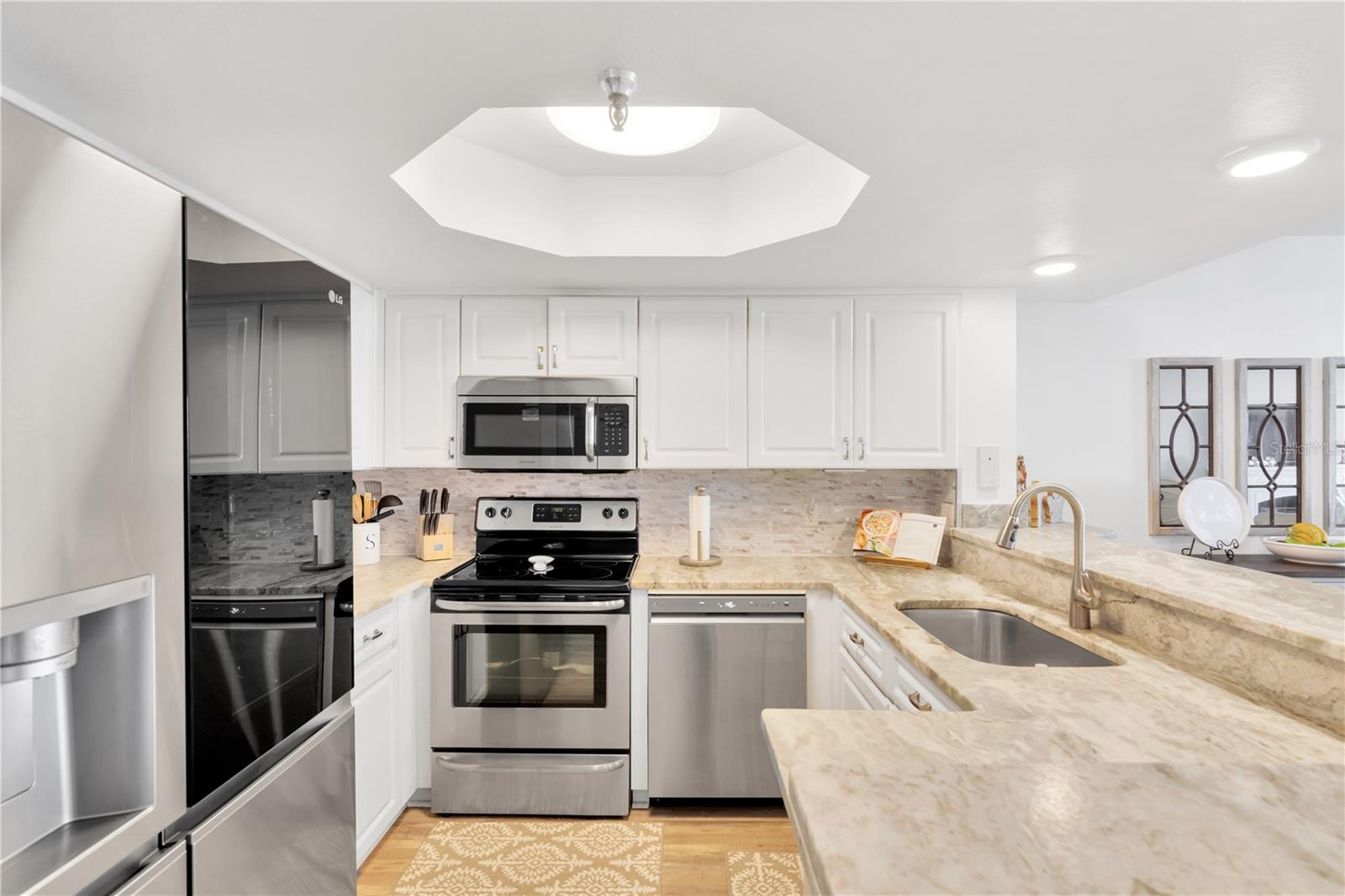Notice the beautiful detailing with your designer lighting, expansive countertops and modern cabinetry.