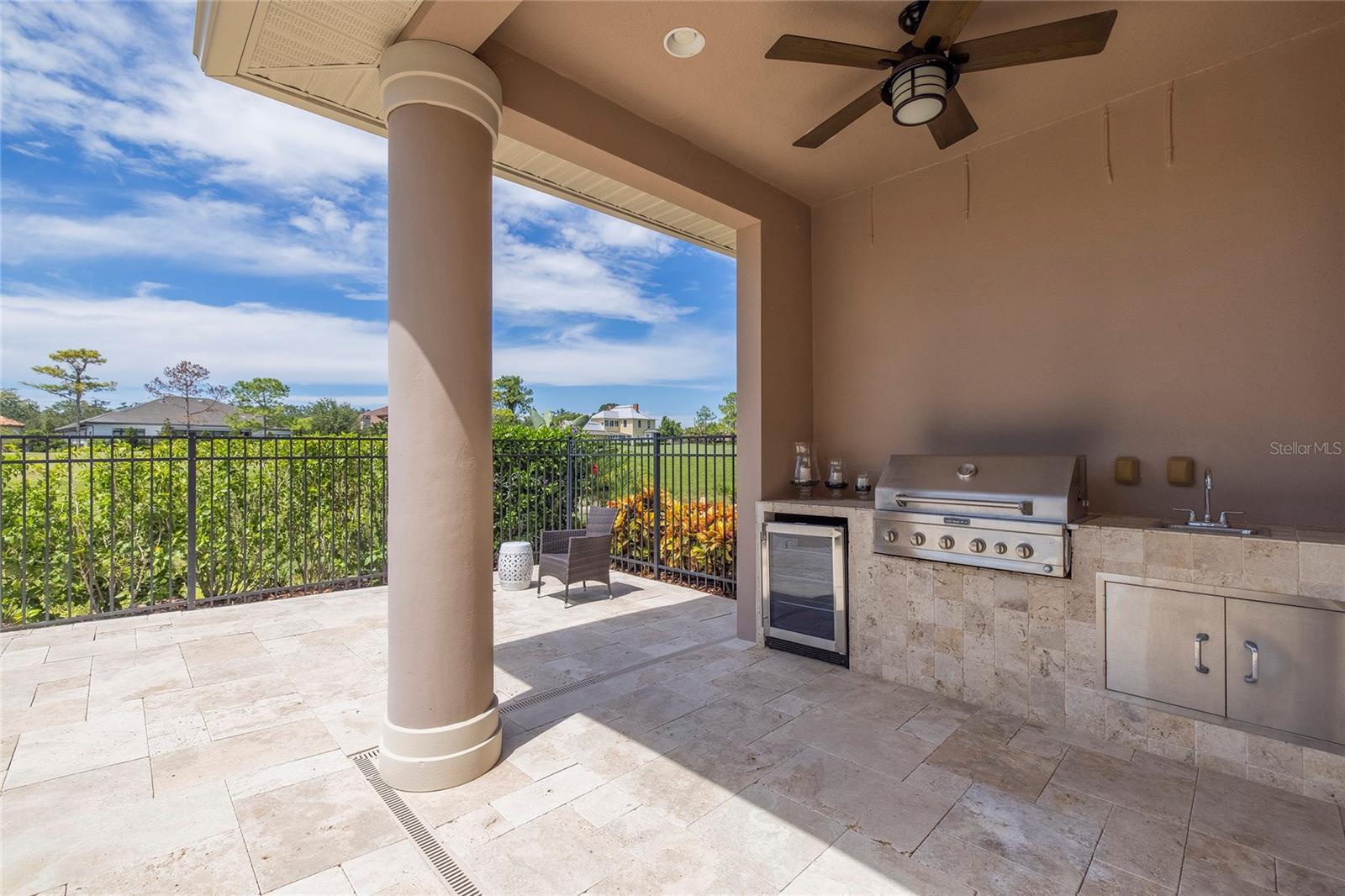 Outdoor kitchen with new beverage refrigerator and new gas grill.