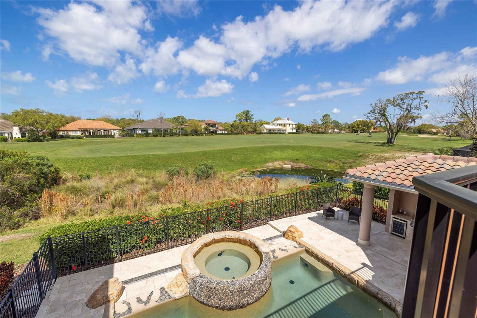 Pool and outdoor spaces have golf course views.
