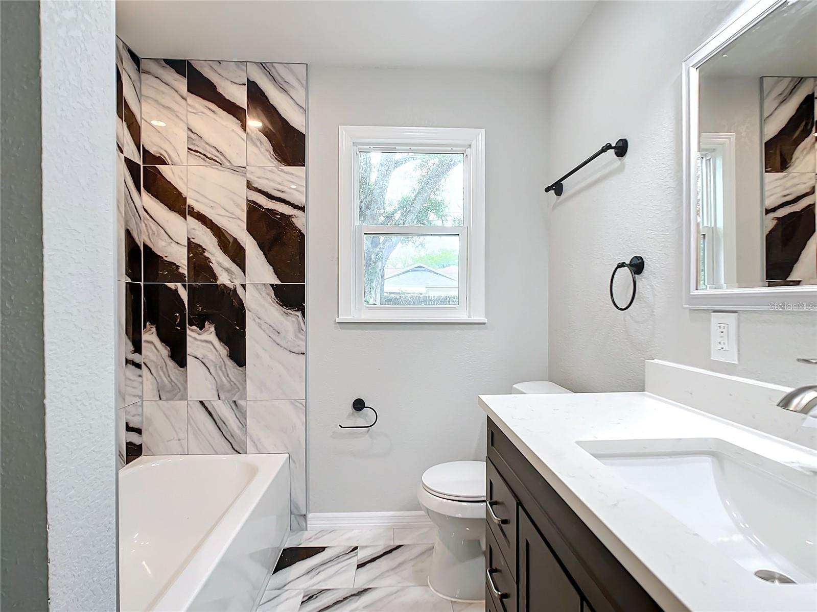 Large bathroom with gorgeous quartz floors and walls
