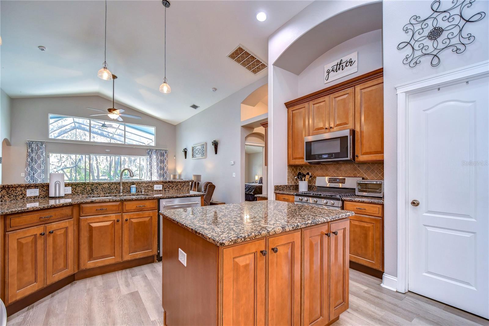 Rich wood cabinets topped with crown as well as a spacious walk-in pantry!