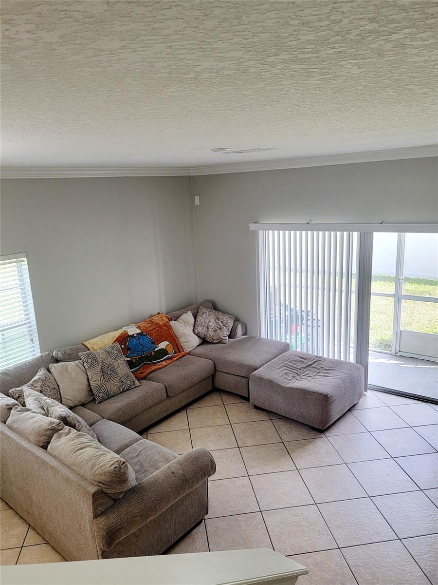 Family Room with sliding doors and view of screen enclosed Patio