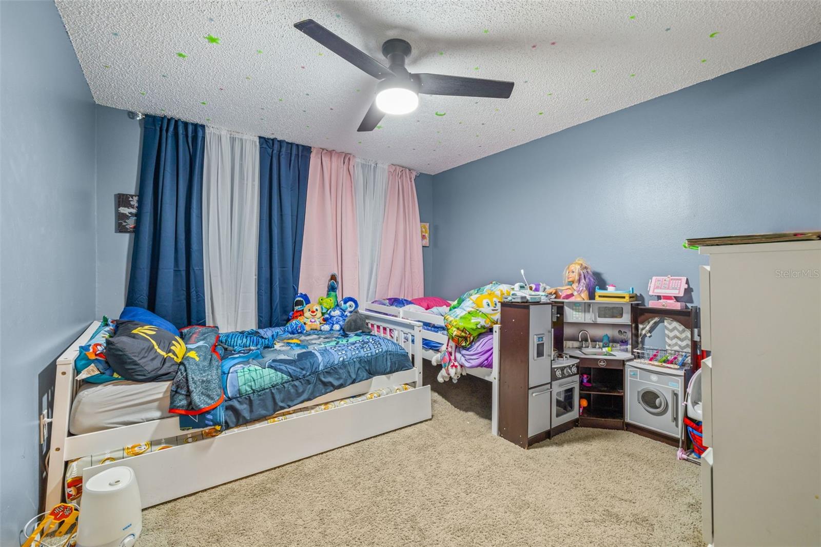 Secondary bedroom! Large room with ceiling fan and plenty of room for the kiddos toys!