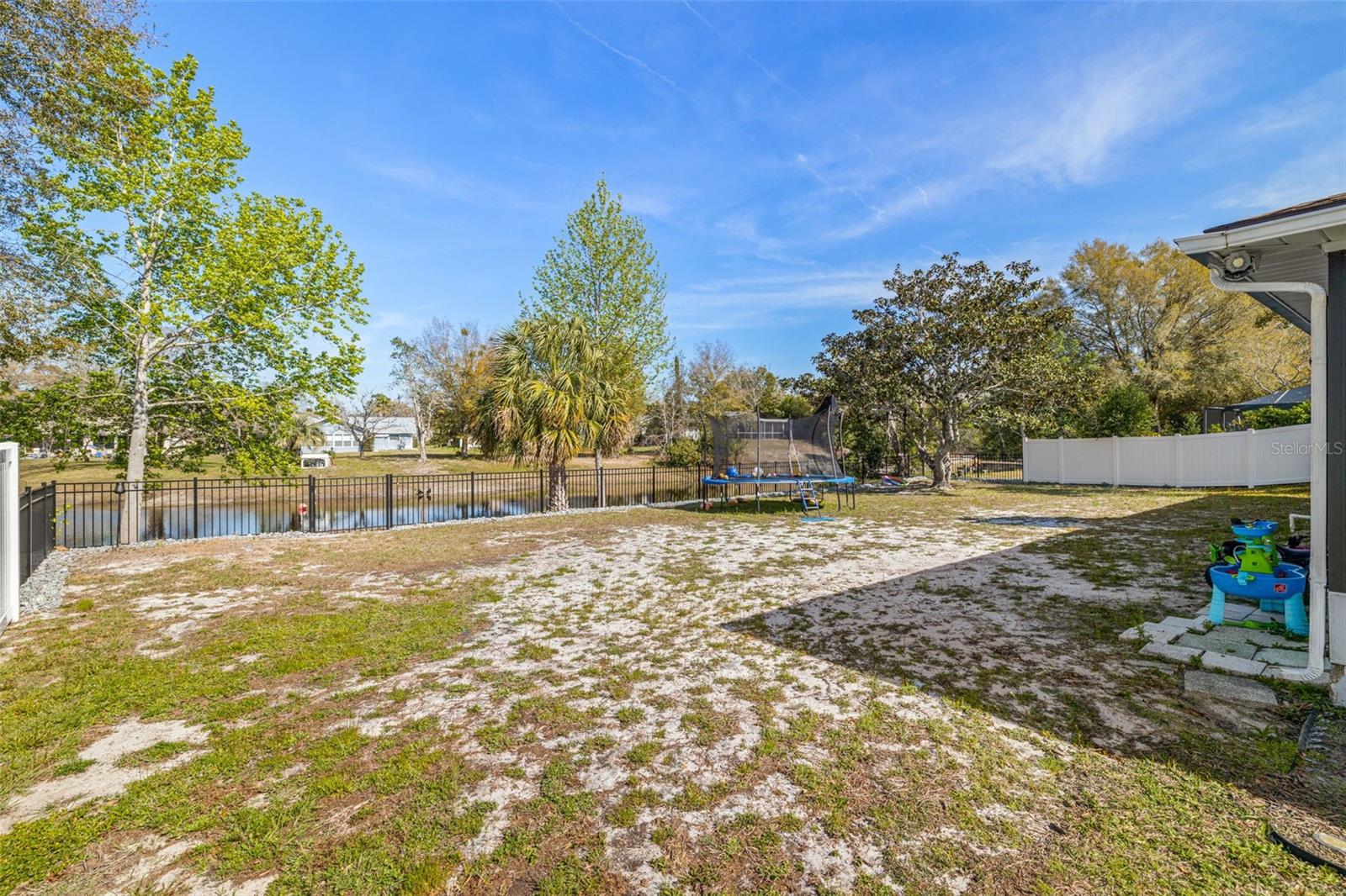 Very large FENCED in lot with an nice pond view!  No neighbor directly behind you!
