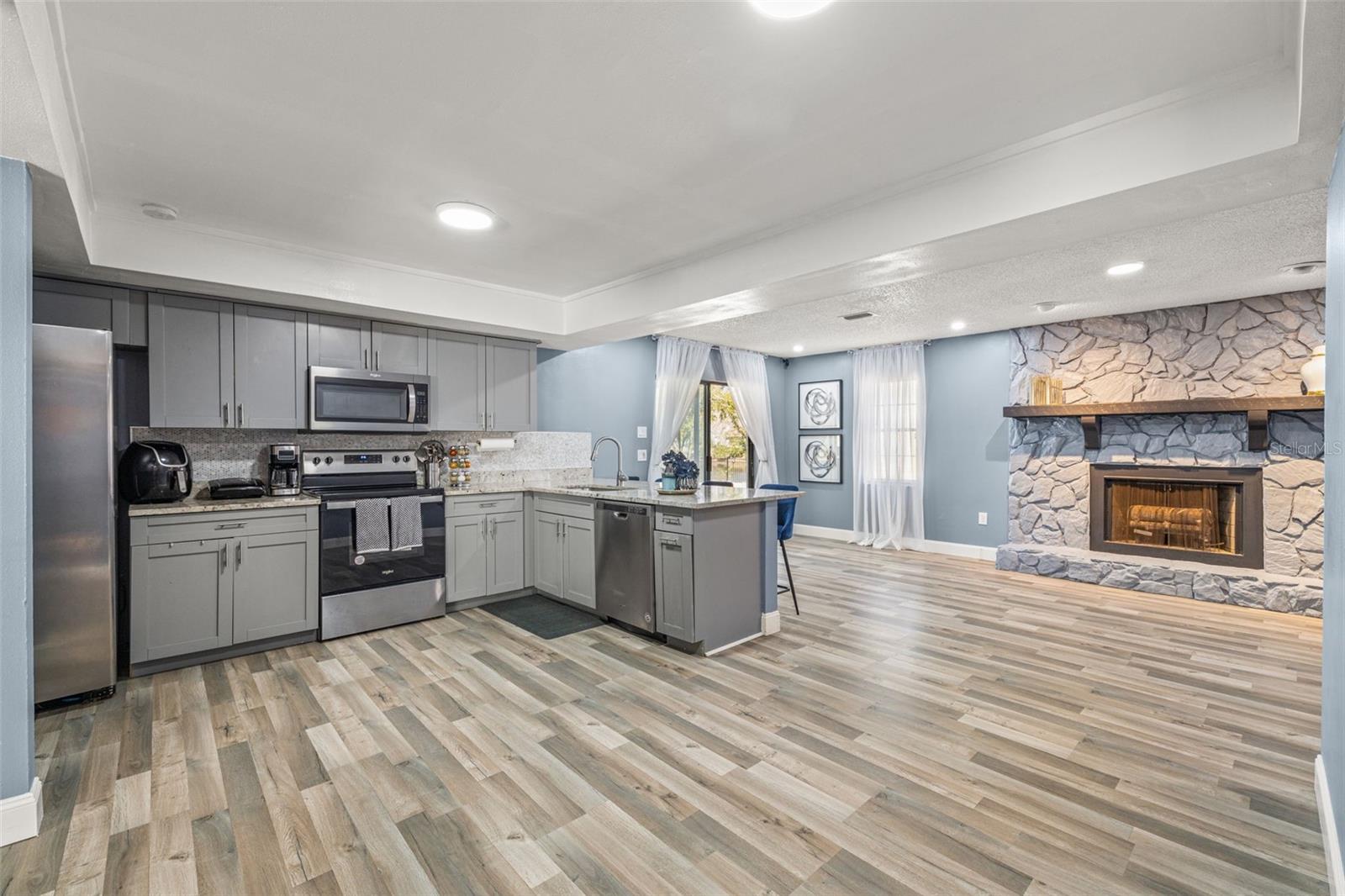 Look at this GORGEOUS kitchen! Completely renovated with new appliances, cabinets, countertops, sink and designer backsplash.  This kitchen opens to the  family room and an additional eating area.