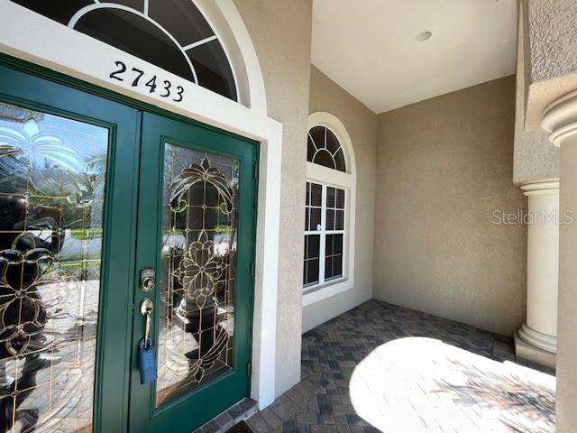 Elegant etched glass front entryway double doors as well as room for a couple of rockers on front porch. or a swing