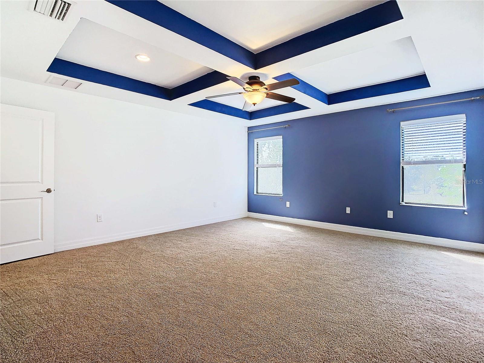Owners bedroom featuring coffered ceiling