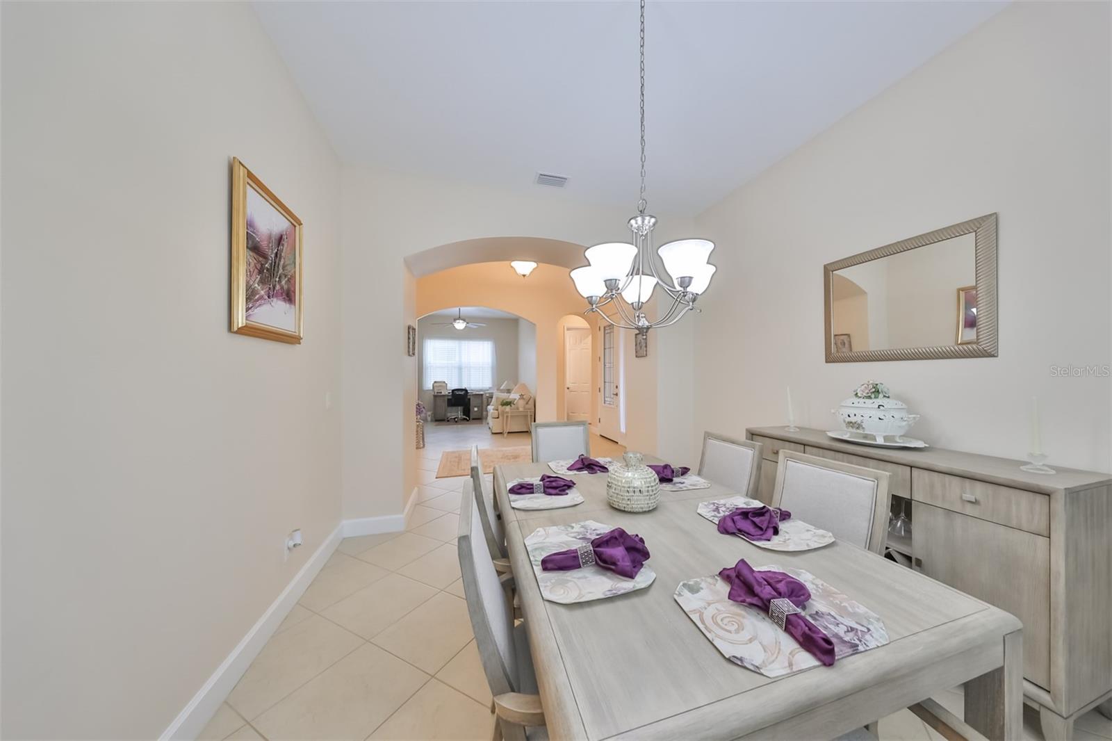 Across from the den is an intimate dining room, perfect for family and guests.  Offering that sense of privacy without looking right into the kitchen.  NOTE:  THE DINING ROOM FURNITURE CONVEYS WITH THE SALE OF THE HOUSE.