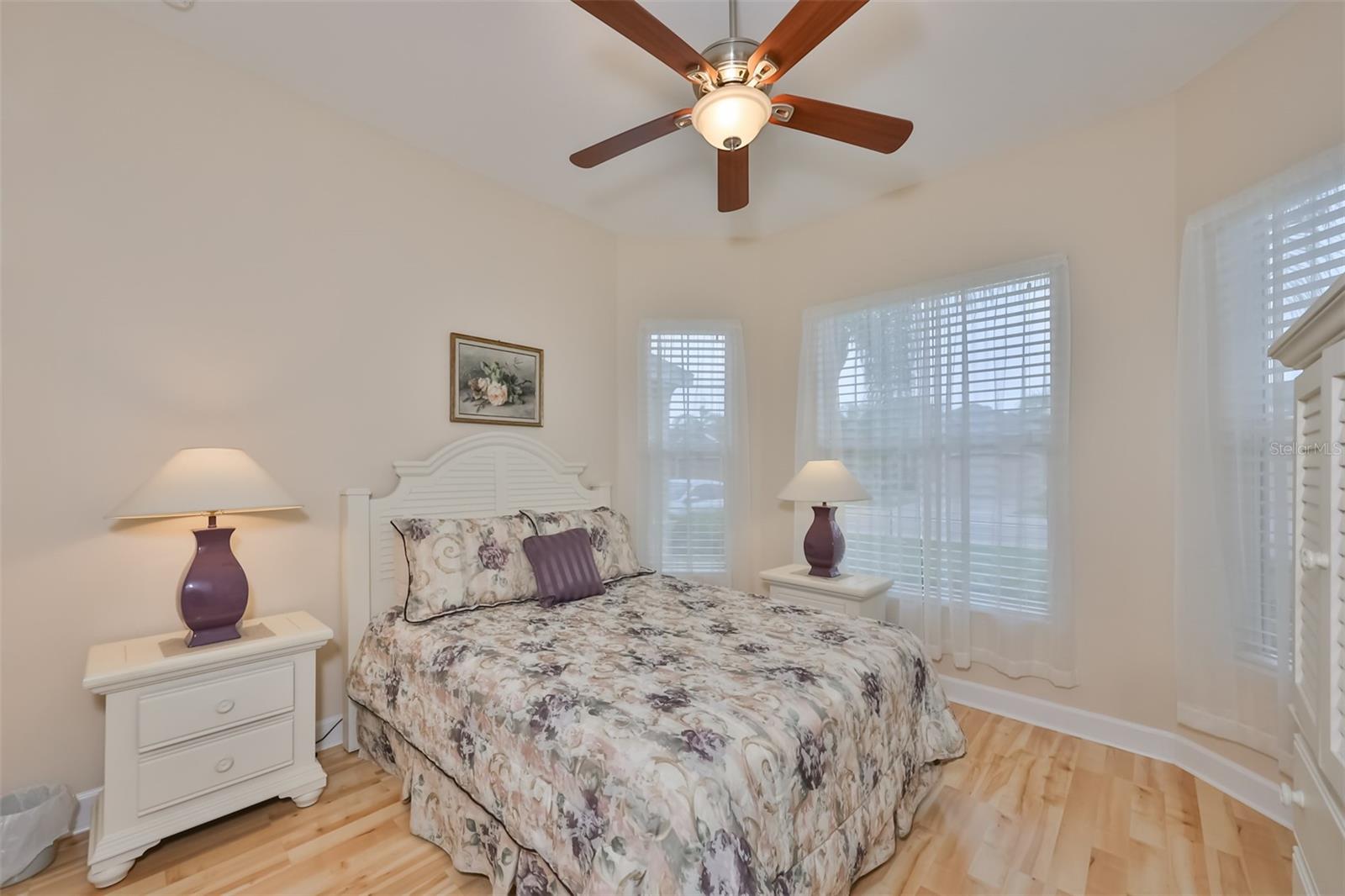 Bedroom #2 has beautiful large wrap around windows for ample natural lighting and lovely laminate flooring.
