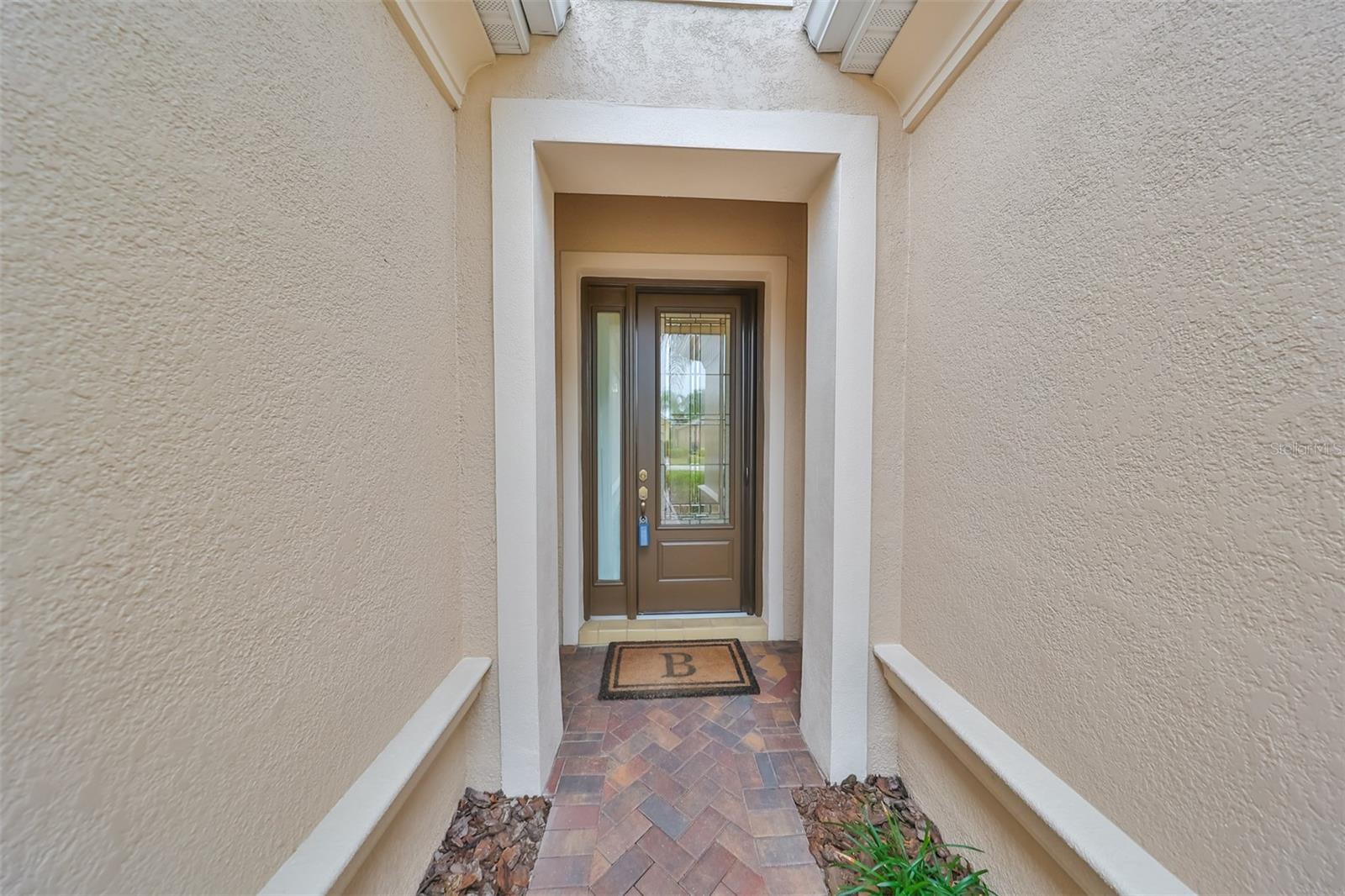 The lead-glass door entrance to this luxury home is beautifully manicured and well maintained. Walking to the front door or up and down the street, you immediately feel the "pride of ownership" in this community.