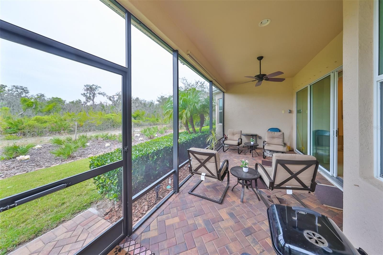 Enclosed screened rear Lanai has custom pavers and lots of privacy, as the home backs up to the Manatee State Park.  There are no concerns about neighbors building behind you.