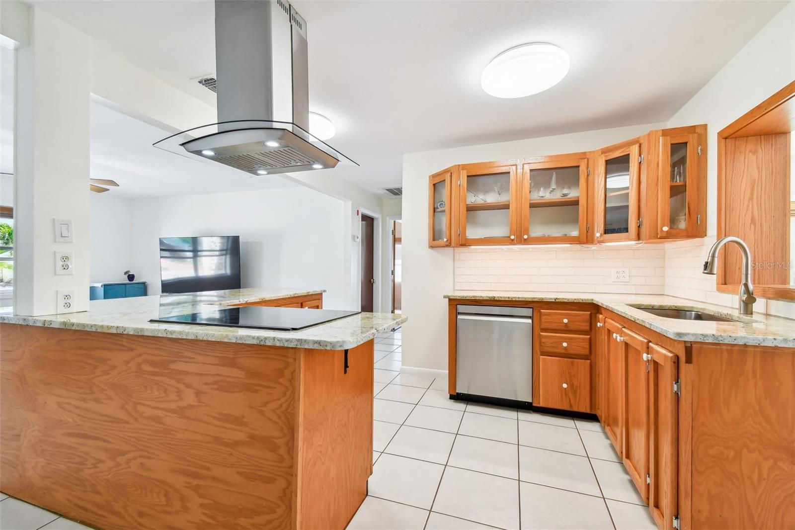 An open concept remodeled kitchen seamlessly blends sleek design elements, functional space, and abundant natural light, fostering a dynamic environment ideal for effortless entertaining.