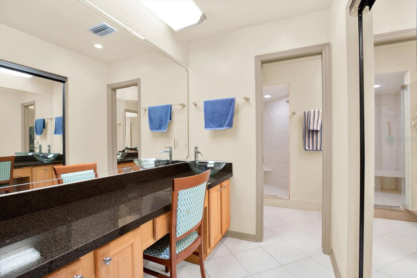 The bathroom has two separate sinks and a nice walk-in shower.