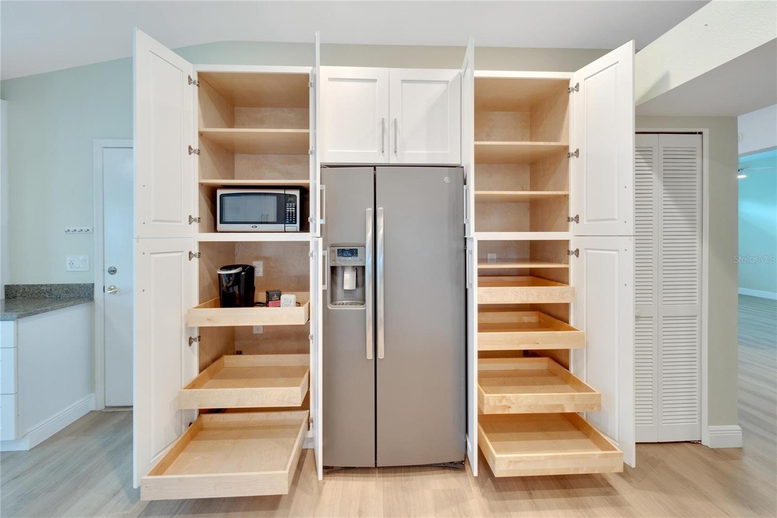 Many pull out drawers for pantry/small appliances, complete with electrical outlets installed