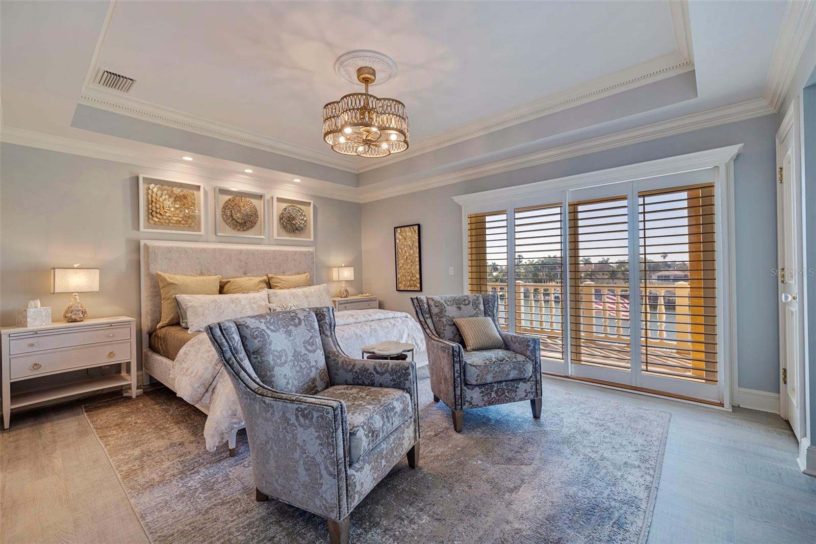 Exquisite primary suite with waterside balcony, ensuite bath, gorgeous ceilings and three closets.