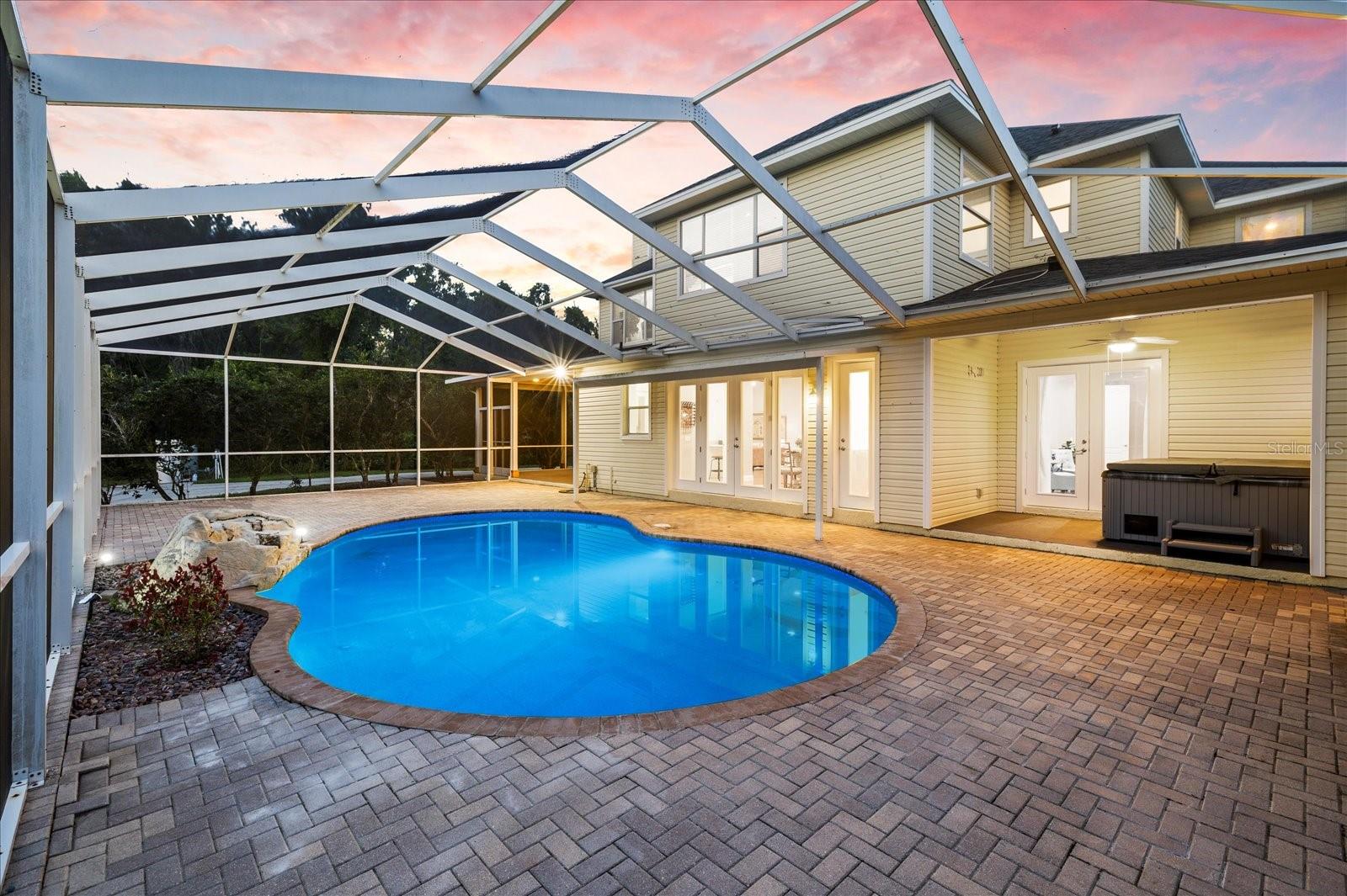 Lovely screened in pool area with patio space.