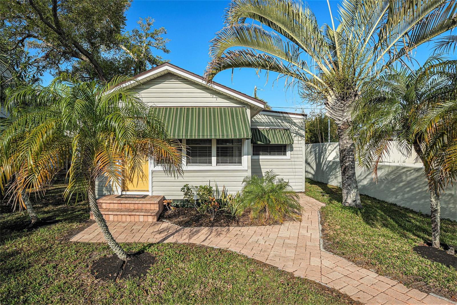 This beautiful coastal dream cottage awaits it's next owner! Could it be you? Charming pavers lead you to your private tucked away cottage just minutes from Gulfport Beach!