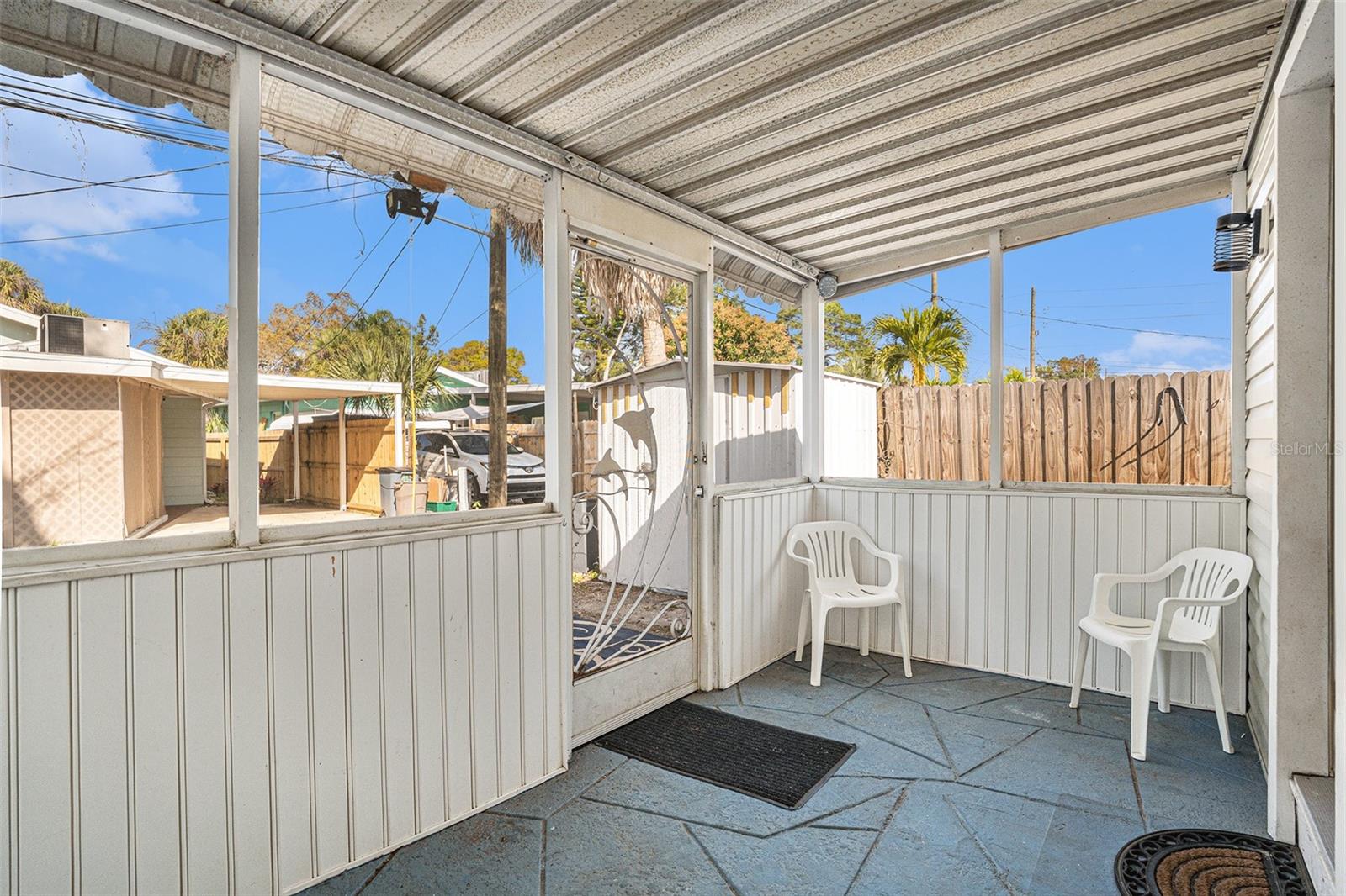 Look at this cute rear screen porch! Just add some cool patio lights and a comfy couch and you got a great place to nap and lounge!