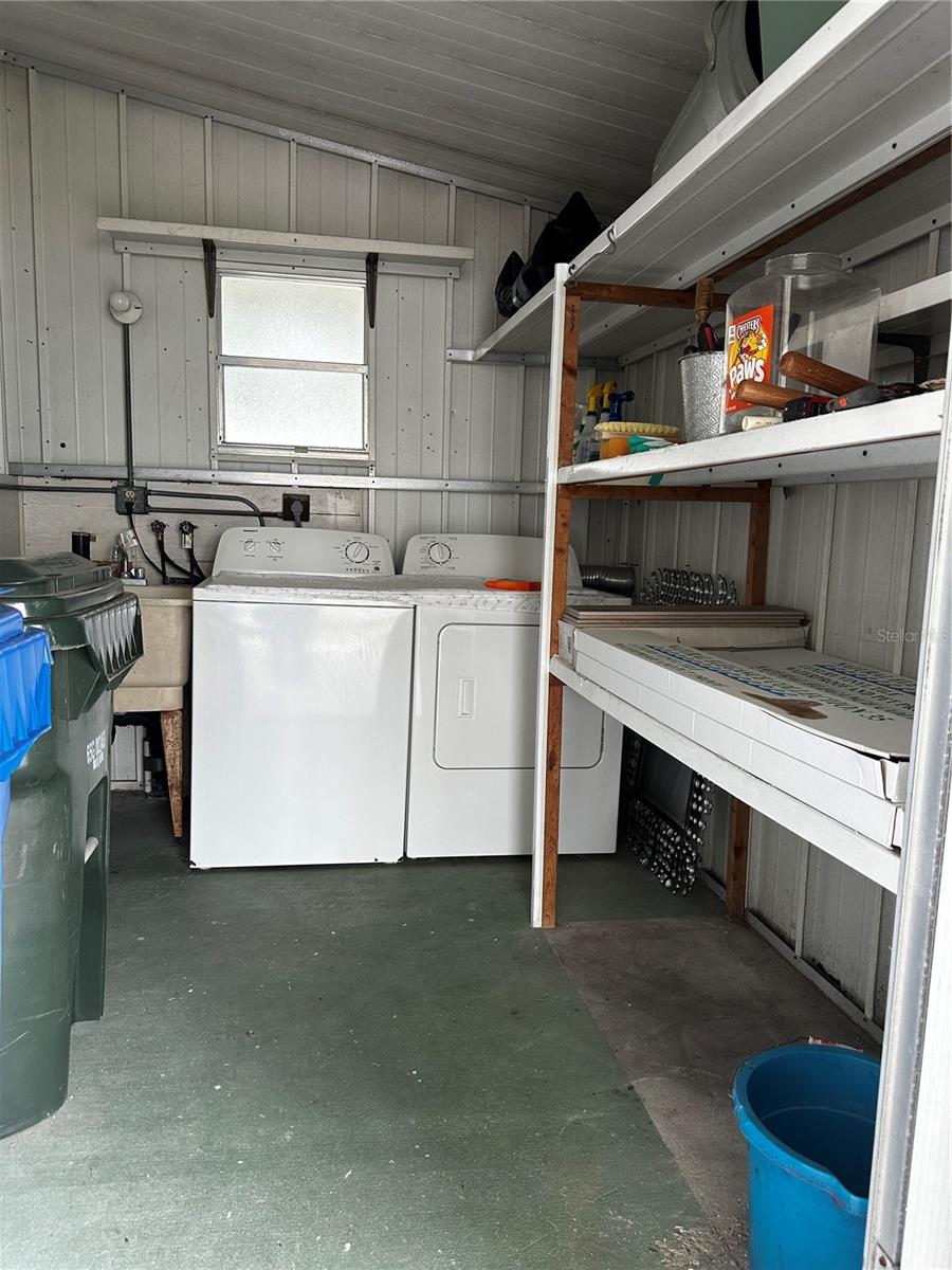 Oversized shed with sturdy shelve, washer/dryer and laundry tub