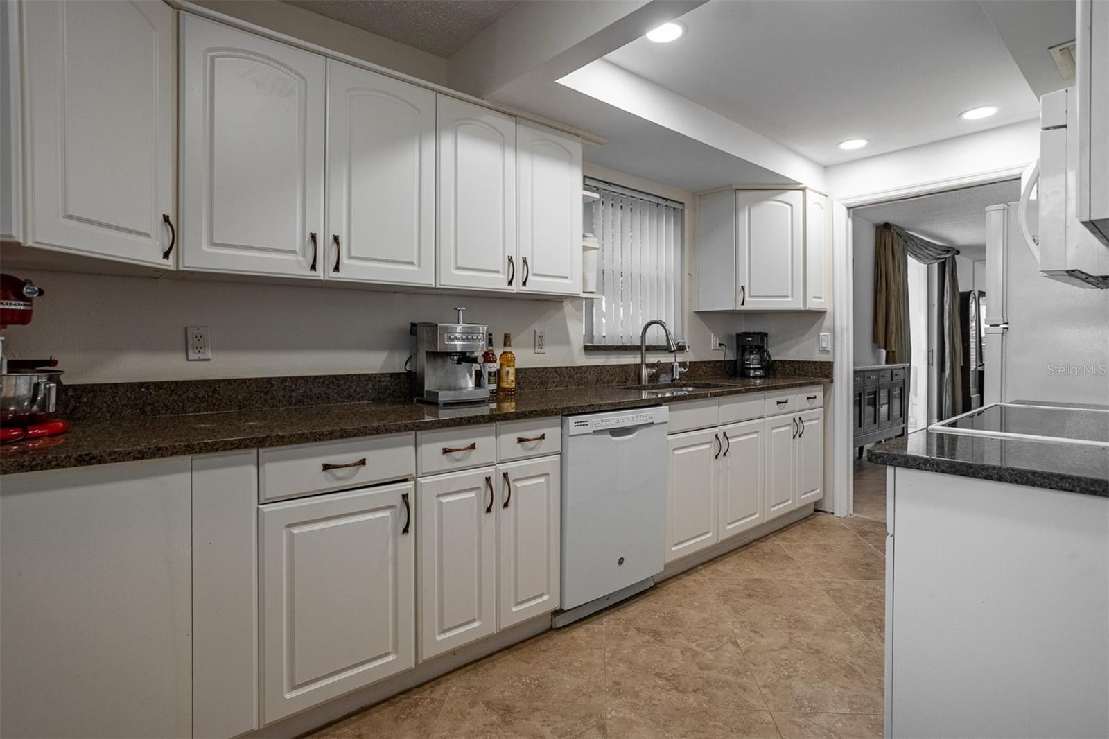 Expanded kitchen with newer granite counter tops and updated lighting features