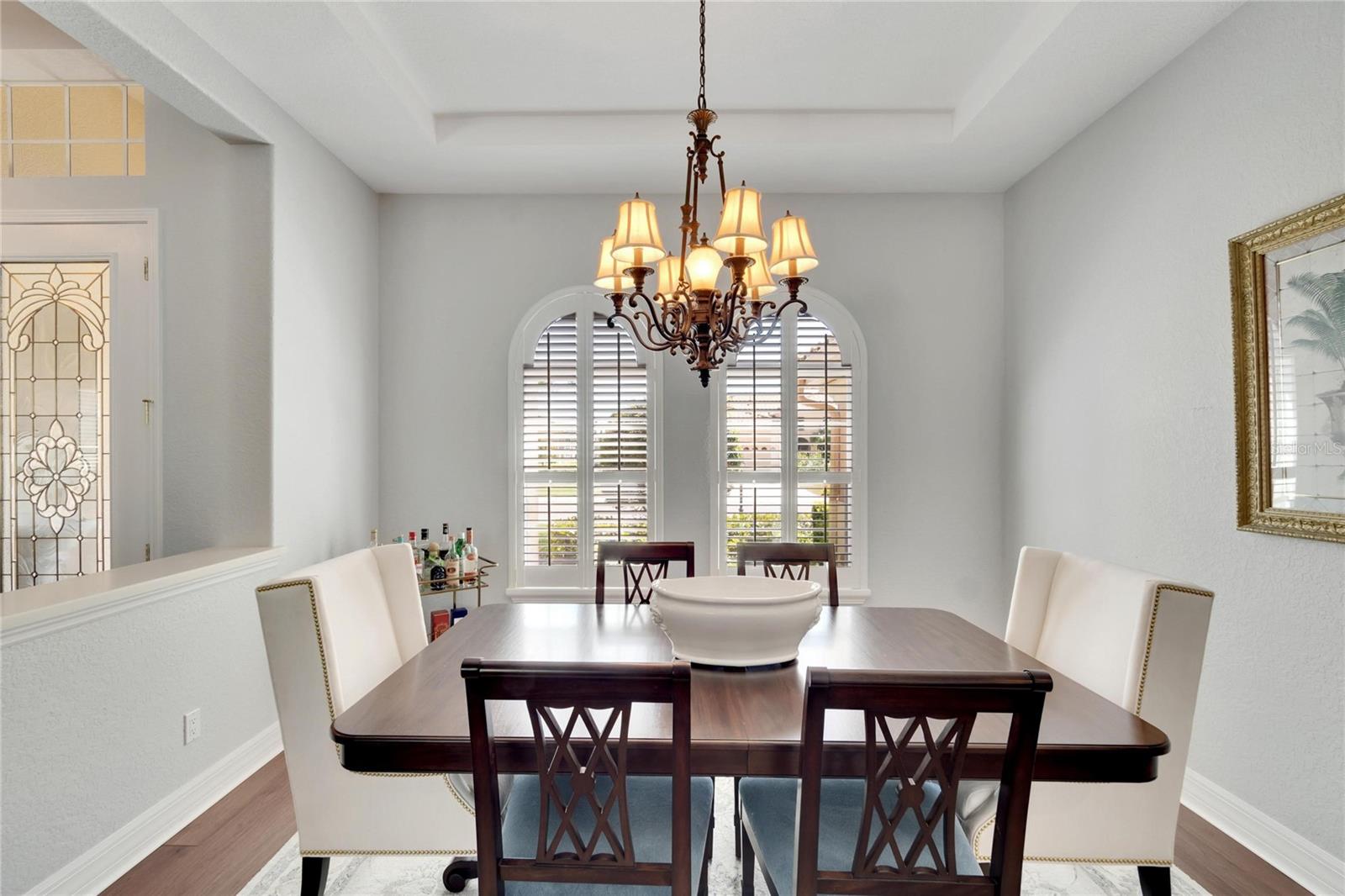 Open Concept Design for flow - yet this Dining Room feels nestled in this space and looks elegant with plantation shutters and trey ceiling.