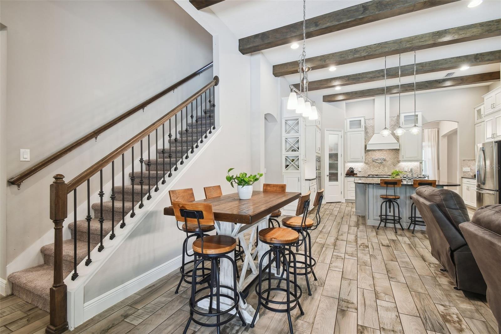 Gorgeous wood beams throughout the living room, kitchen and dining room