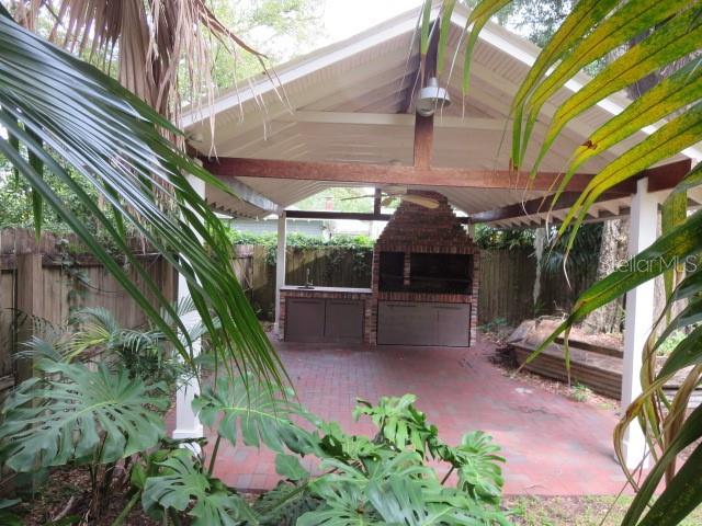 What a beautiful landscape feature!  Cool off under the tall bamboo on this handsome brick patio - or invite friends for a quiet al fresco lunch.  The kitchen is just steps away.