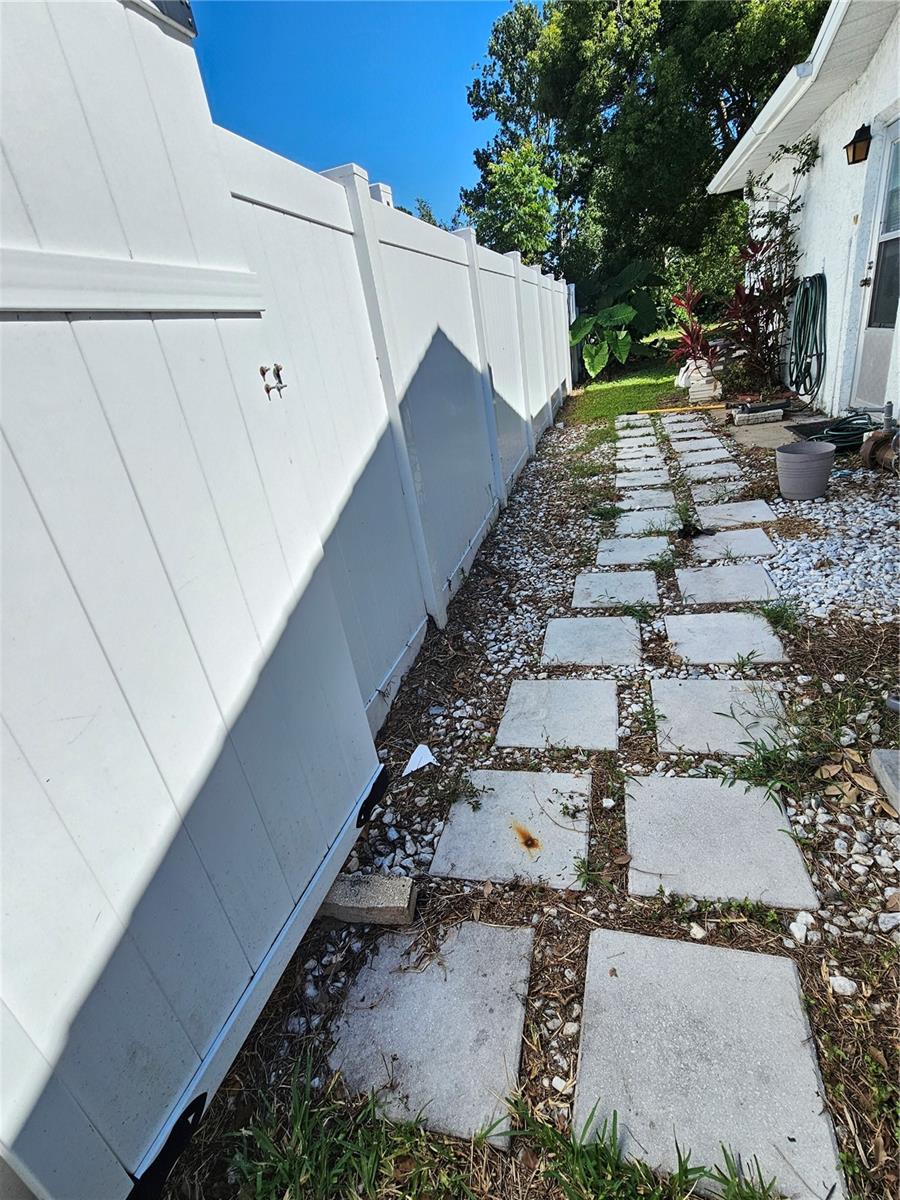 Side path to the left of the house, door to access garage is on the right side.