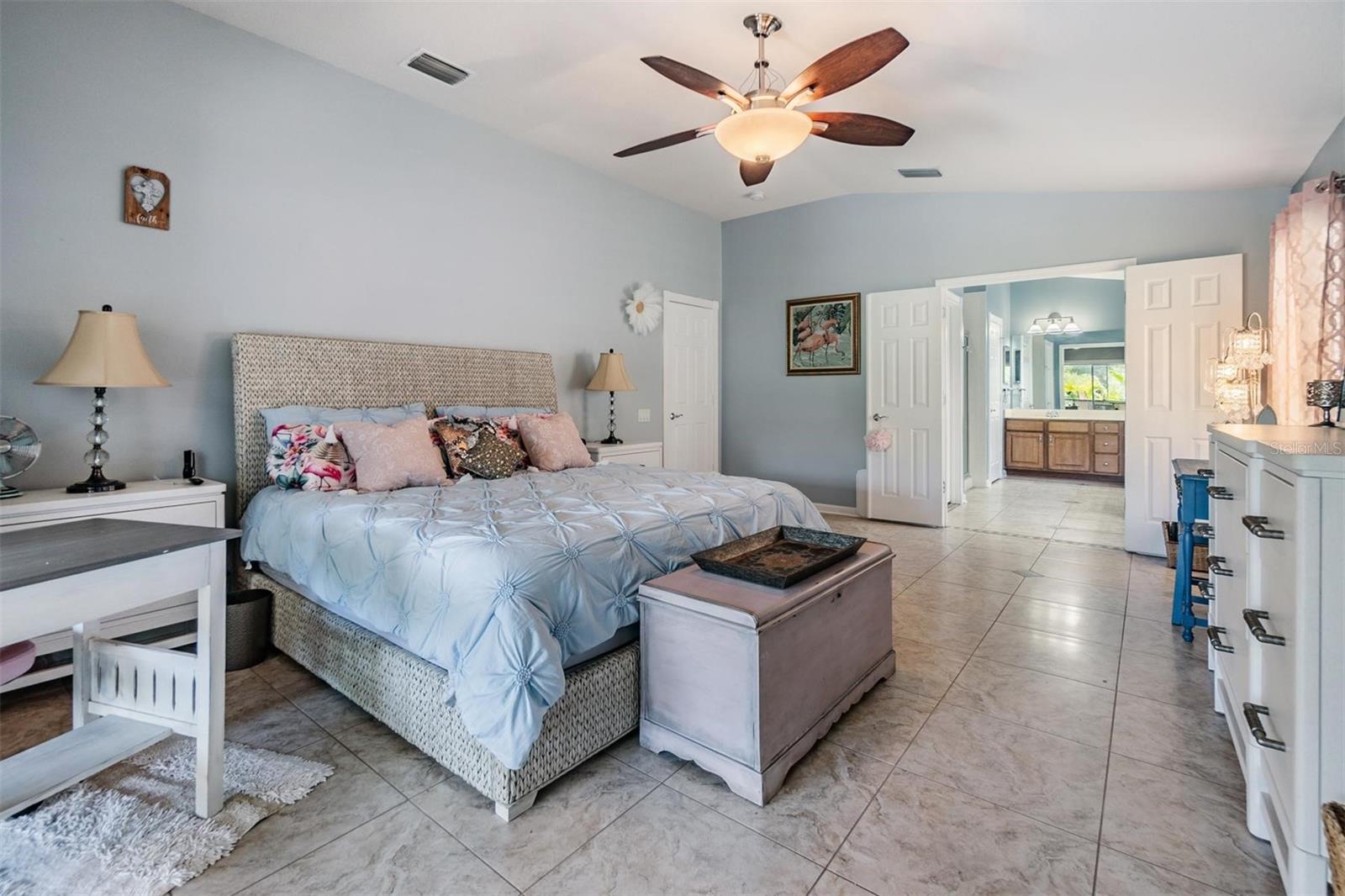 Huge Master Bedroom, Vaulted Ceilings, Ceiling Fan, Tile Flooring with views of the pool and conservation.