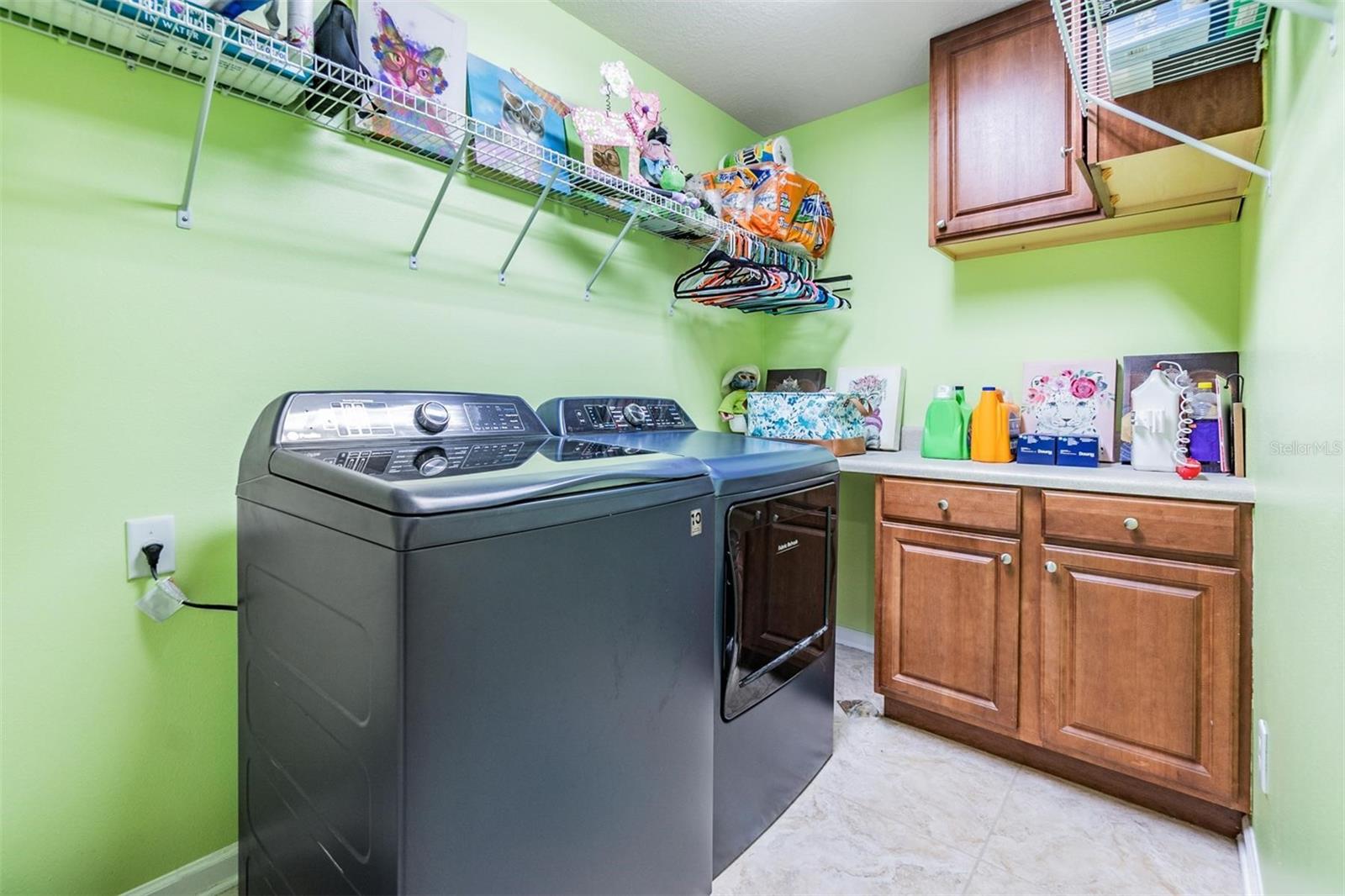 Laundry Room with tile flooring and Cabinet Space.