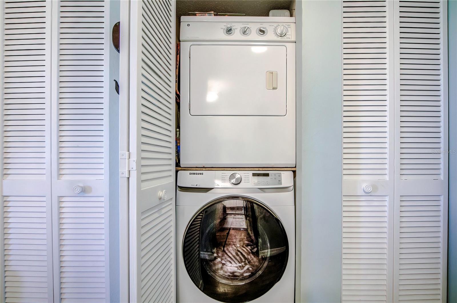 Laundry closet with washer and dryer.