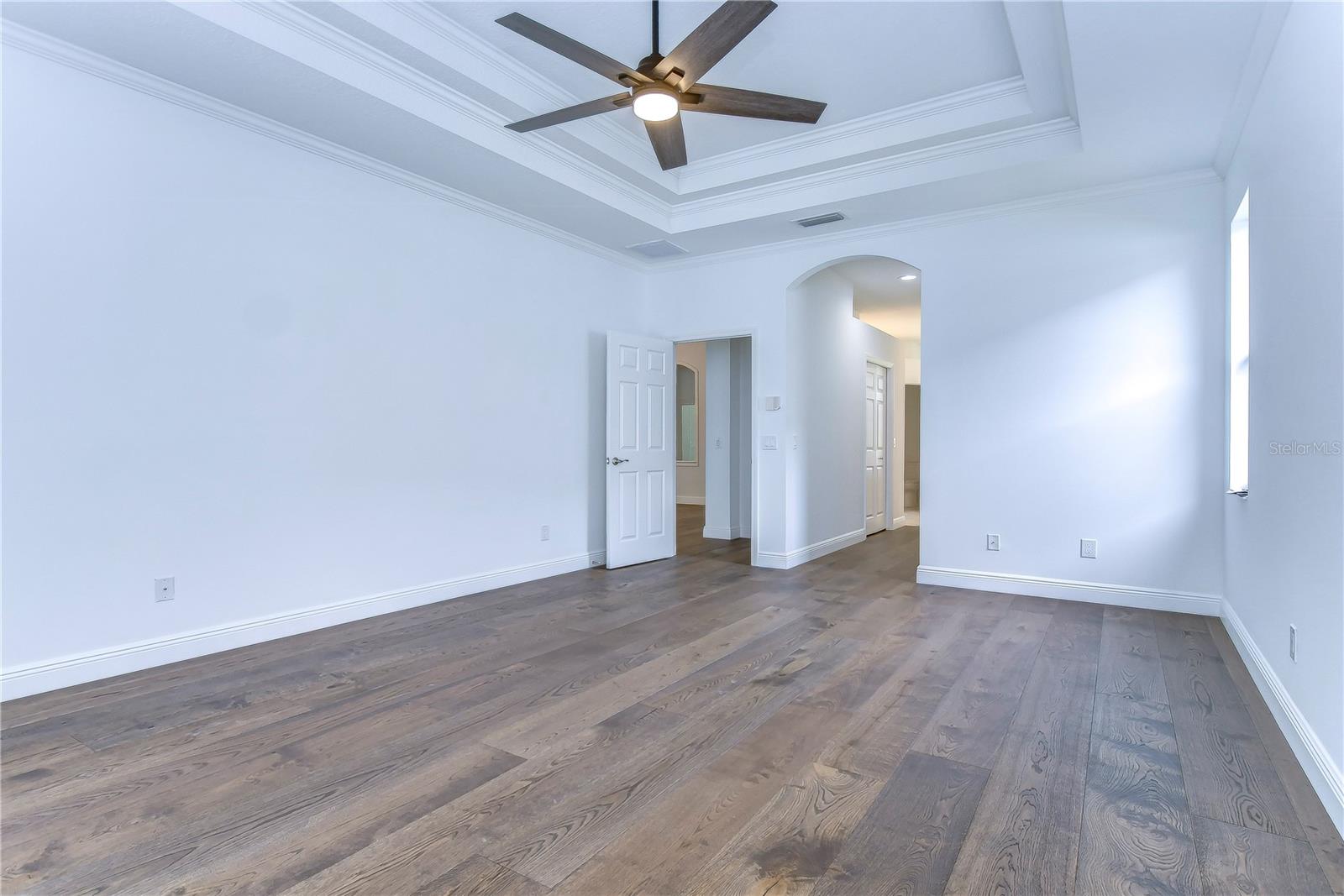 Bathed with natural light from the windows, beautiful hardwood floors and tray ceiling!