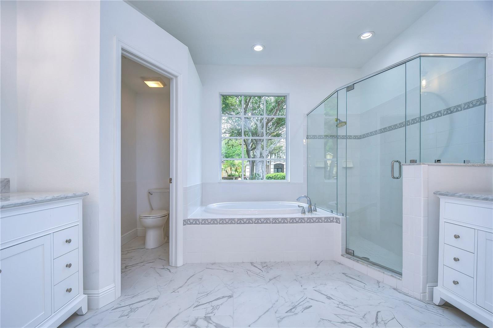 Beautifully remodeled with separate vanities, HUGE walk-in shower and garden tub!