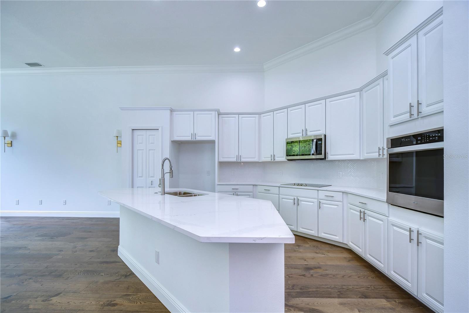 Sleek 42” white cabinets, luxurious Calacatta quartz countertops, and top-of-the-line stainless steel appliances!