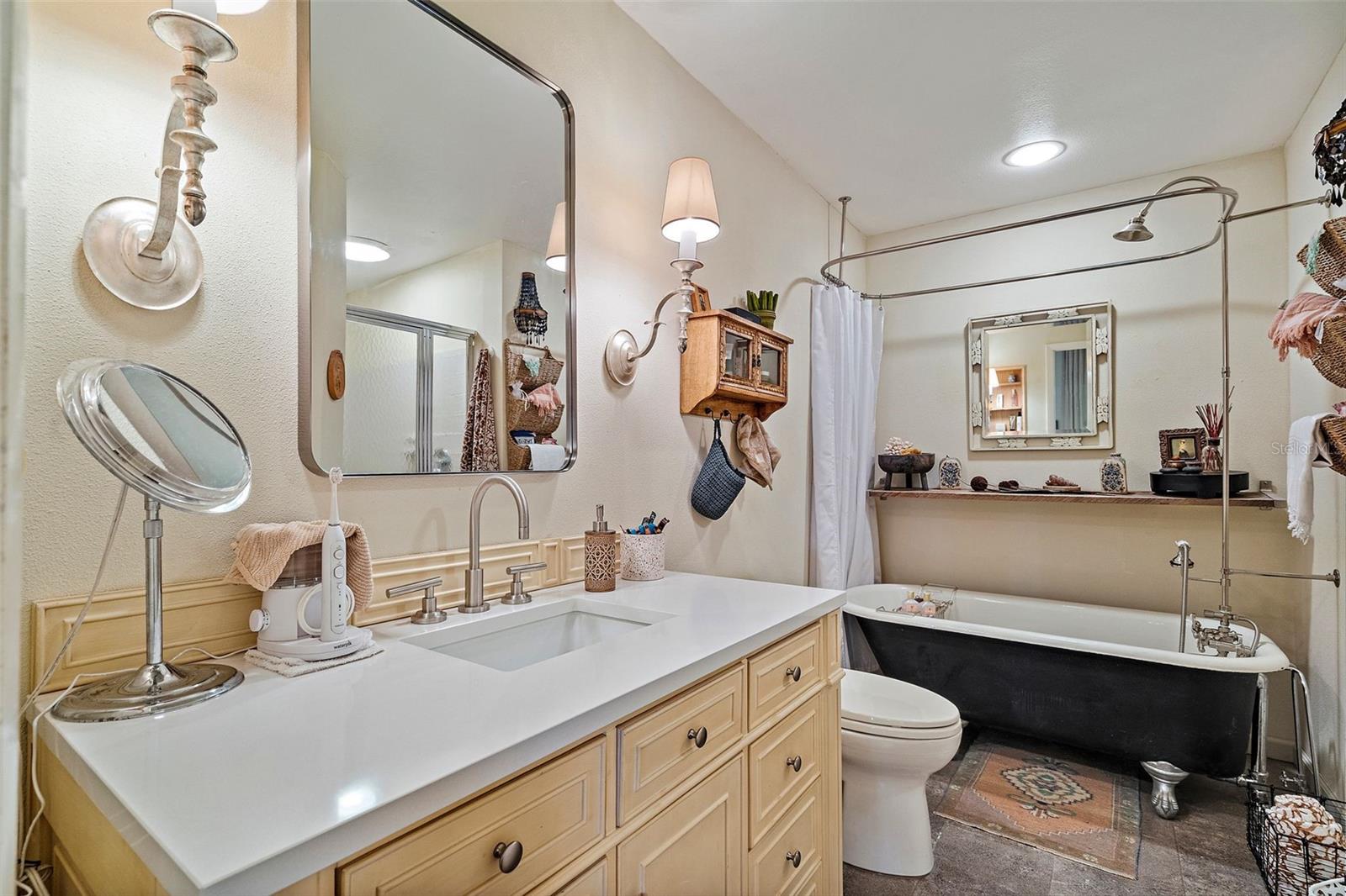 Primary Bathroom with Luxurious Cast Iron Clawfoot Tub With Shower and the Large Vanity with Quartzite Countertop