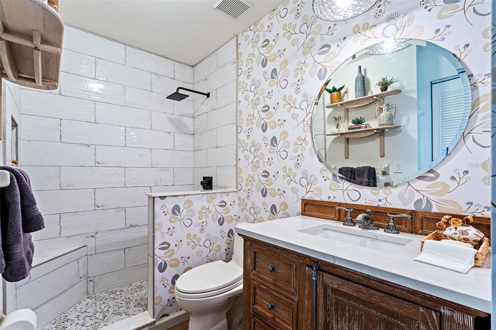 Guest Bathroom Has a Large Vanity and Beautiful Walk-in Shower with Custom Tiles