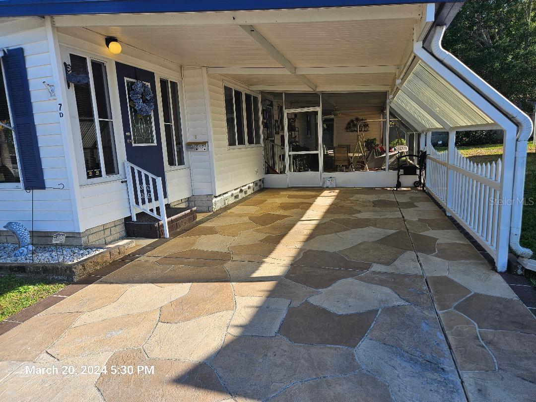 extra wide carport with privacy fence and screen