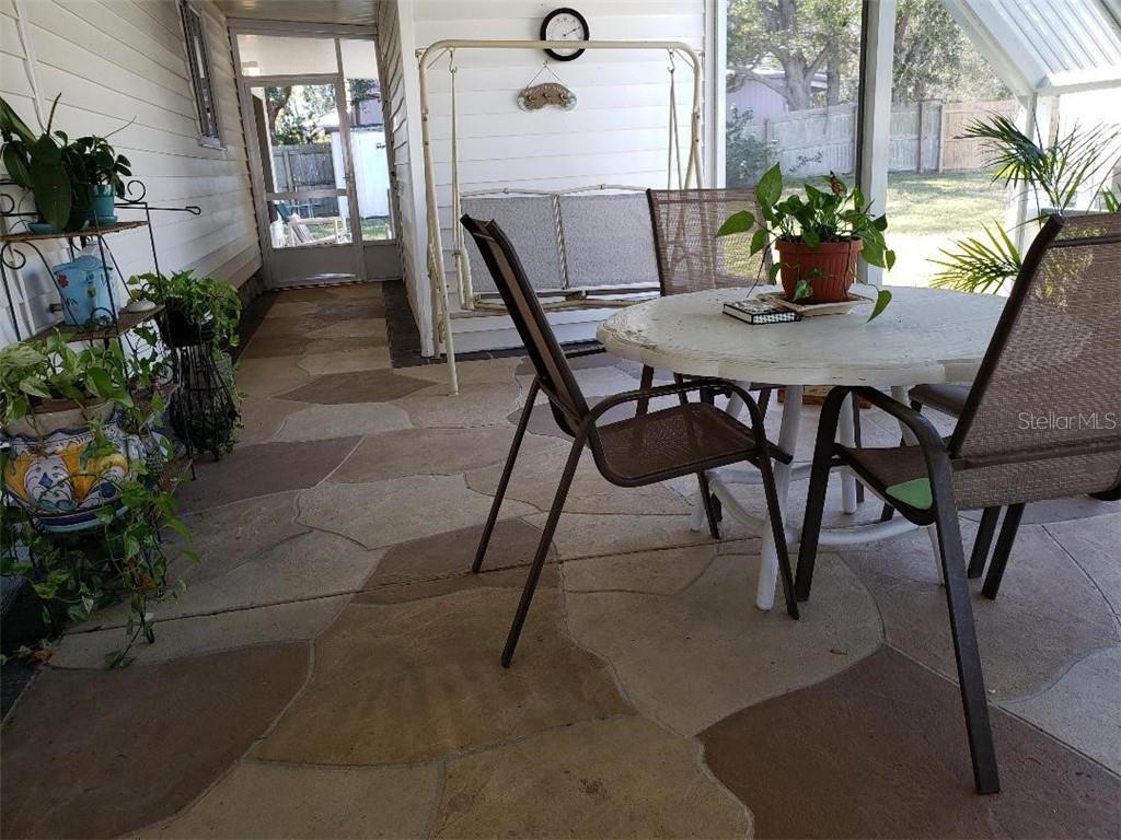 screened porch with stamped concrete floor
