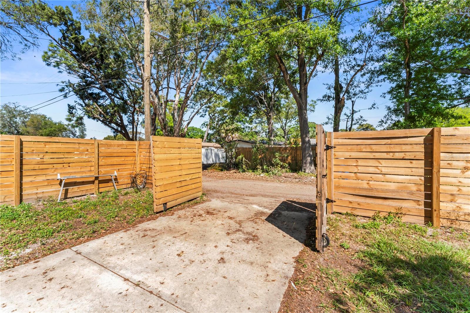 Dual Gates that lead to the Driveway and 1 Car Garage Great for parking a Boat or and RV