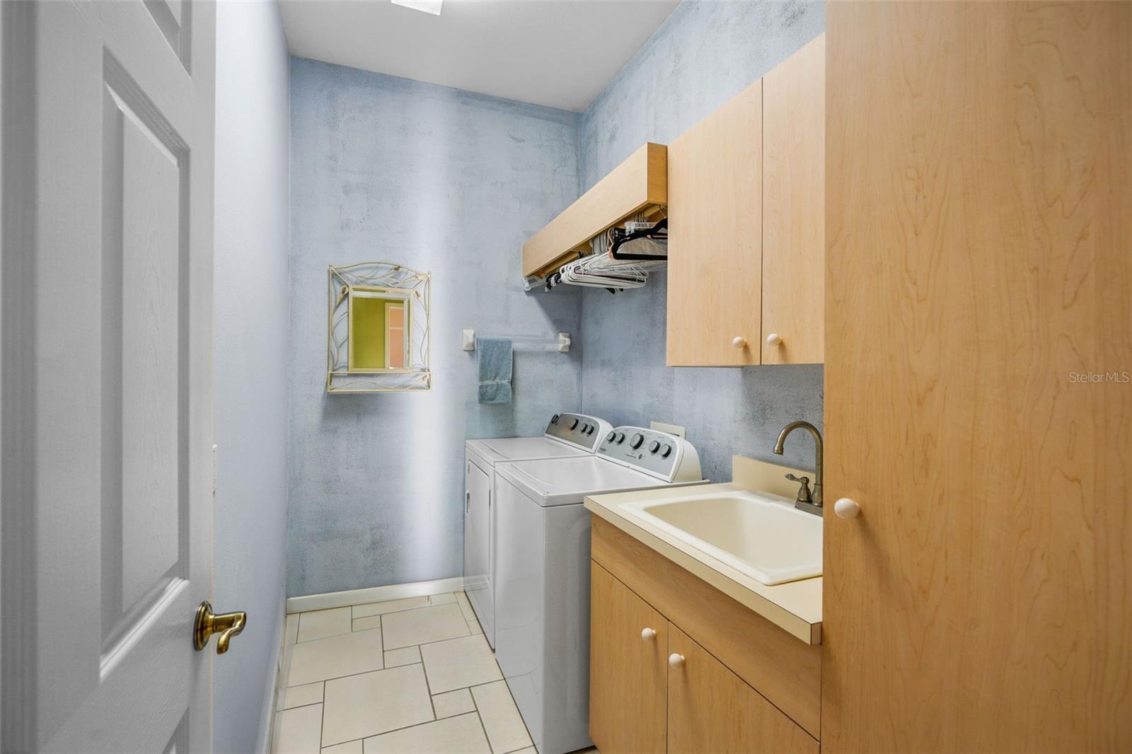 Laundry room with utility sink and cabinetry
